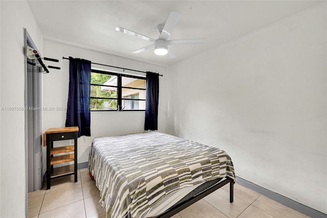 tiled bedroom with ceiling fan