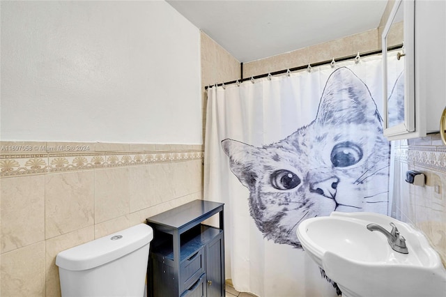 bathroom featuring a shower with curtain, toilet, tile walls, and sink