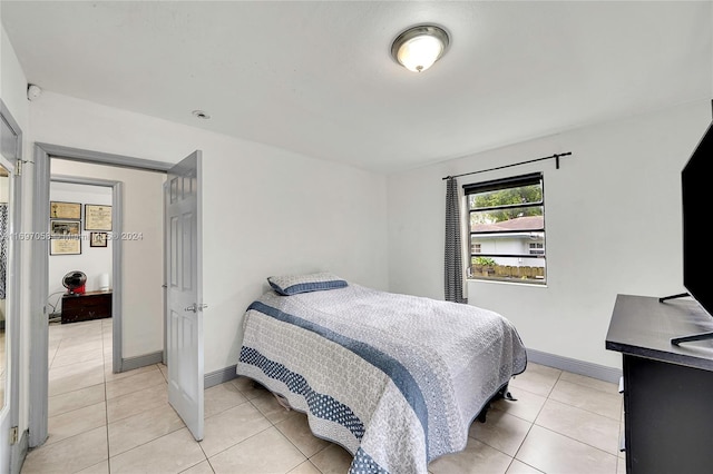 bedroom with light tile patterned floors