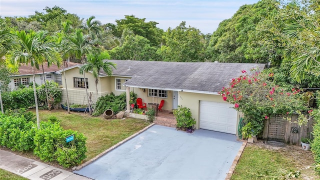 single story home featuring a garage and a front lawn