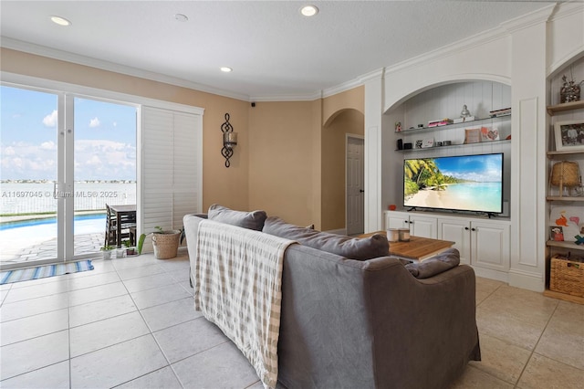 tiled living room featuring ornamental molding and built in features