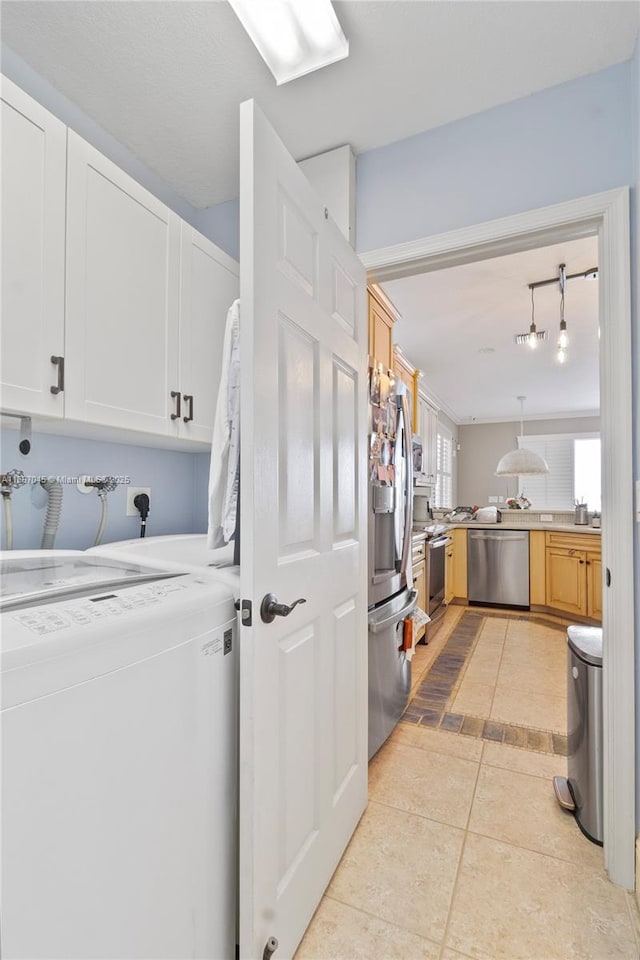 washroom featuring sink, cabinets, light tile patterned floors, track lighting, and washer / clothes dryer