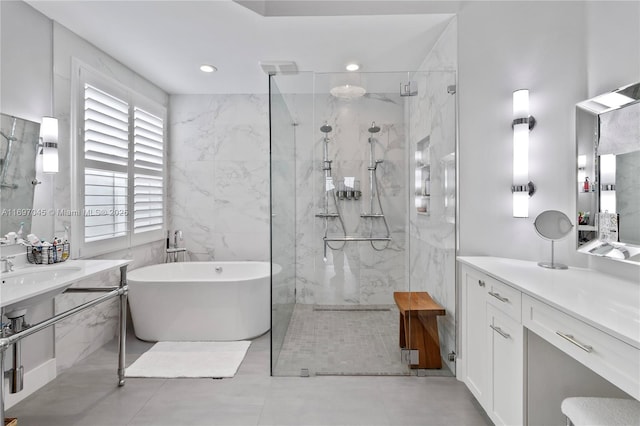 bathroom featuring tile walls, sink, and shower with separate bathtub