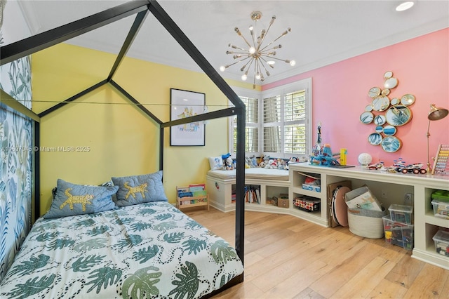 bedroom with an inviting chandelier, crown molding, and hardwood / wood-style floors