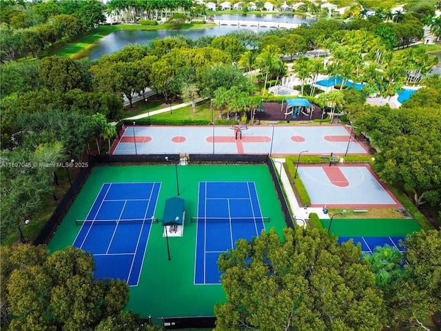 view of tennis court featuring a water view