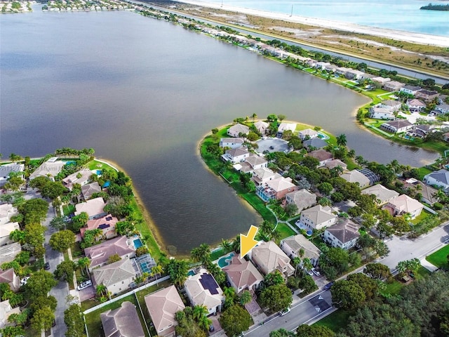 bird's eye view with a water view and a beach view