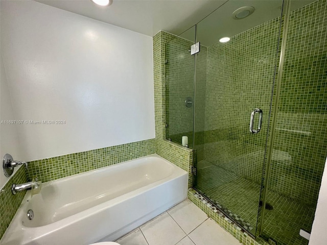 bathroom featuring tile patterned flooring and independent shower and bath