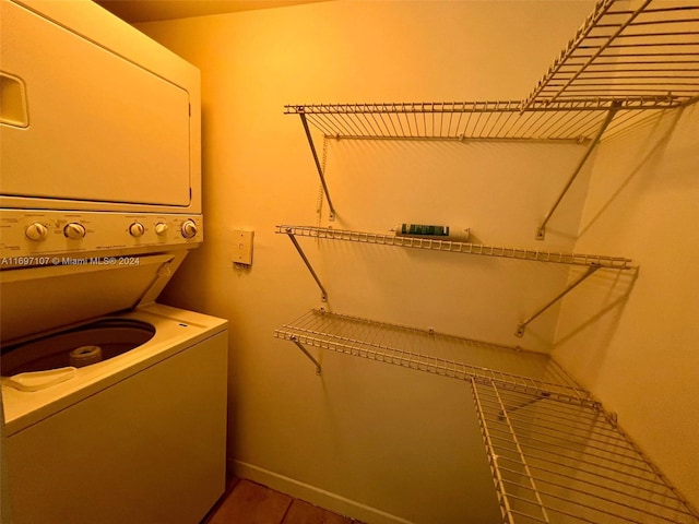 clothes washing area with stacked washer and clothes dryer