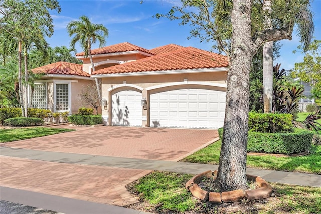 mediterranean / spanish-style house with a garage