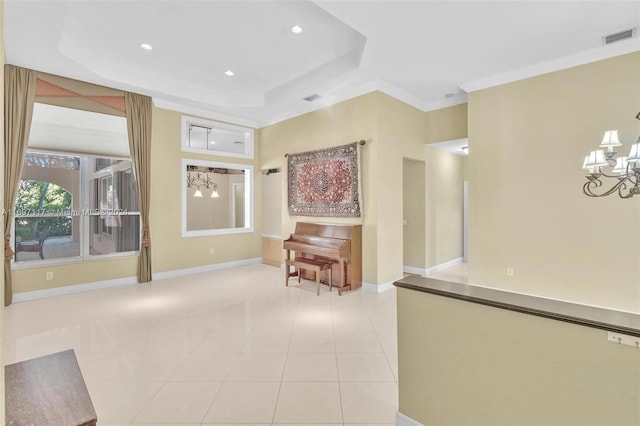 hallway with light tile patterned flooring, a raised ceiling, and an inviting chandelier