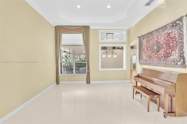 misc room featuring light tile patterned floors, a tray ceiling, ceiling fan, and crown molding