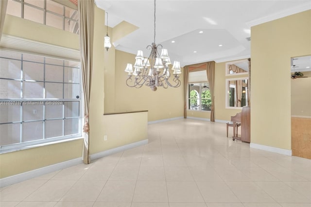 interior space featuring light tile patterned flooring, crown molding, and an inviting chandelier