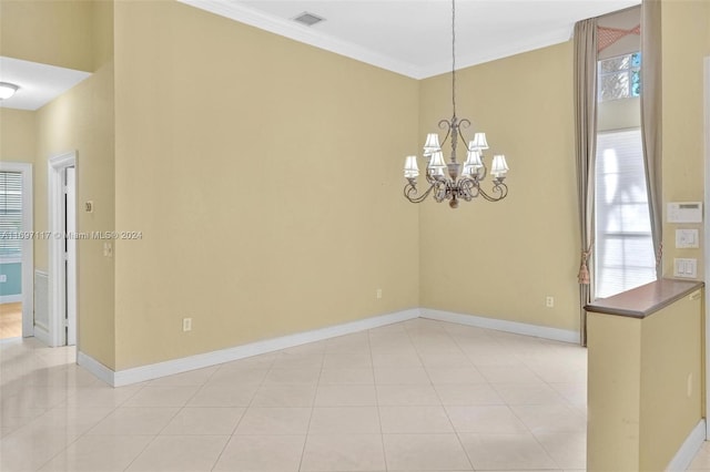 tiled empty room featuring ornamental molding and an inviting chandelier