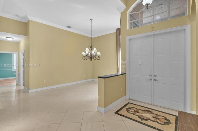 entrance foyer featuring light tile patterned floors, a chandelier, and ornamental molding