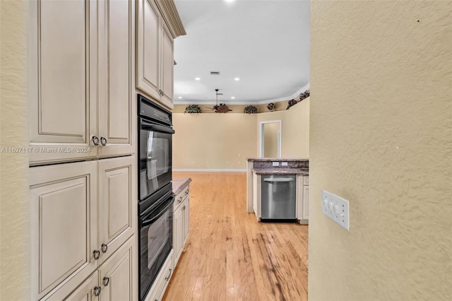 kitchen featuring ornamental molding, light hardwood / wood-style flooring, stainless steel dishwasher, and black double oven