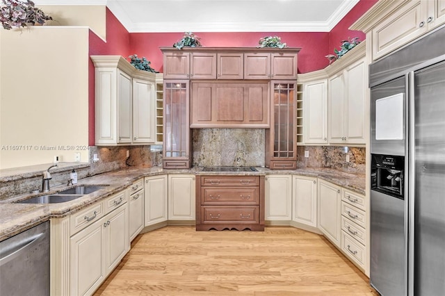 kitchen with sink, stainless steel appliances, backsplash, light wood-type flooring, and ornamental molding