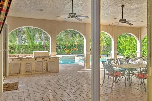 view of patio / terrace featuring sink, grilling area, ceiling fan, and exterior kitchen