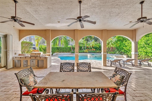 view of patio with area for grilling and ceiling fan