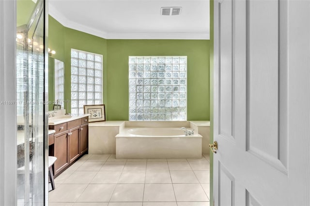 bathroom with tile patterned flooring, vanity, a bathtub, and crown molding