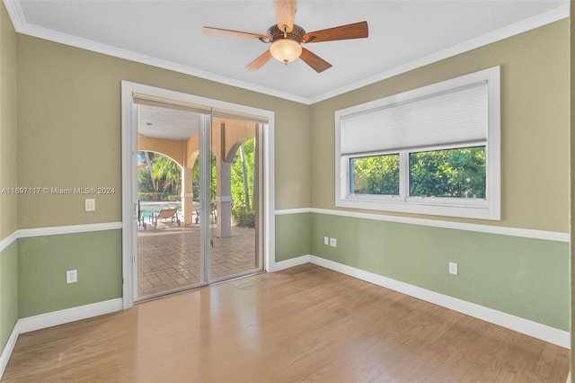 spare room featuring ceiling fan, crown molding, and light hardwood / wood-style floors