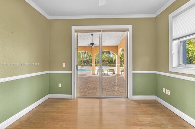 interior space with light hardwood / wood-style flooring, ceiling fan, and crown molding