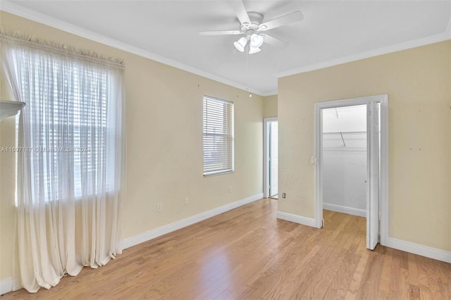 unfurnished bedroom with light hardwood / wood-style flooring, ceiling fan, and ornamental molding