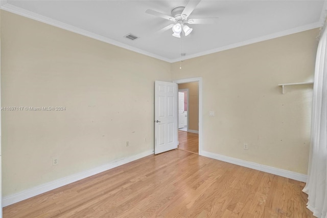 spare room featuring ceiling fan, ornamental molding, and light wood-type flooring