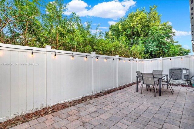 1707 SE 9th Ter, Homestead, FL 33034 - fenced backyard featuring a patio area, central AC unit, and outdoor dining space