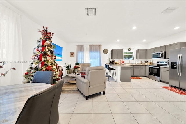 1707 SE 9th Ter, Homestead, FL 33034 - living room featuring light tile patterned floors and recessed lighting