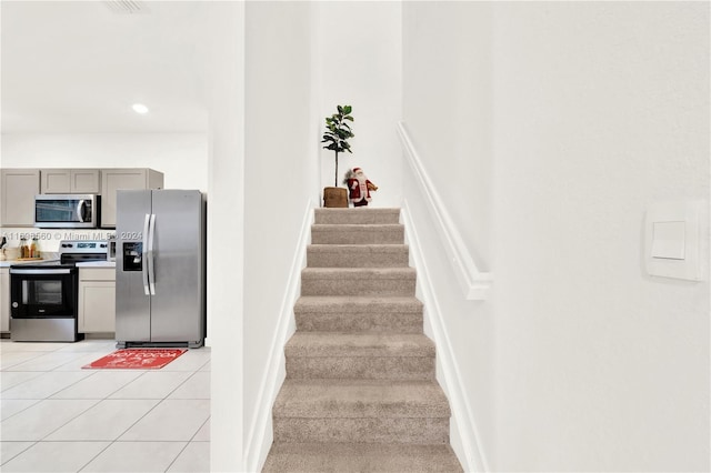 stairway with tile patterned floors