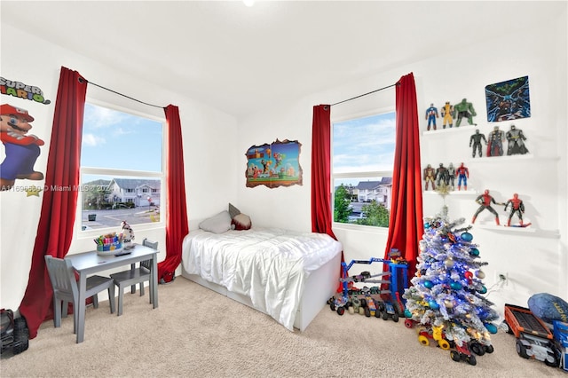 carpeted bedroom featuring multiple windows