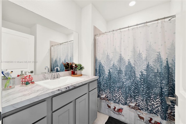 bathroom featuring curtained shower and vanity