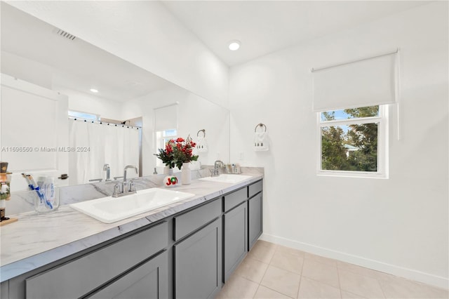 bathroom with curtained shower, tile patterned flooring, and vanity