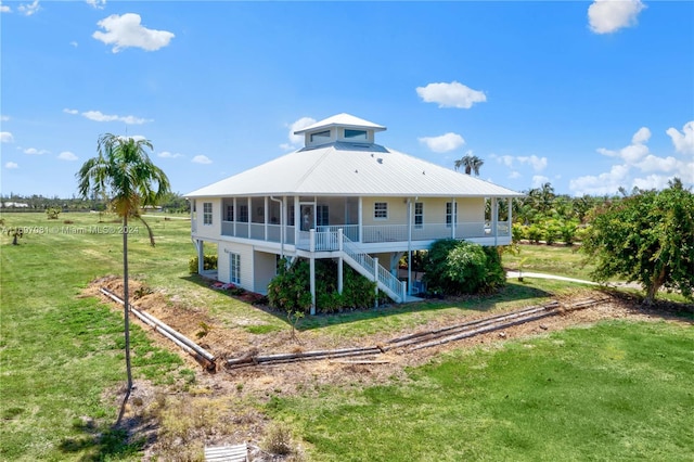 rear view of house with a lawn