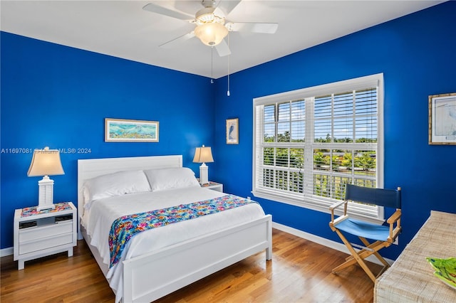 bedroom with ceiling fan and hardwood / wood-style floors