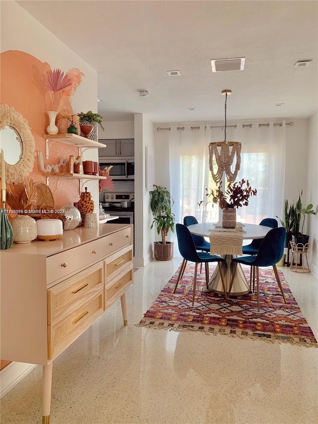 dining area with an inviting chandelier