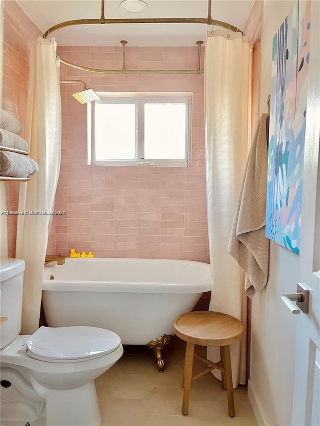 bathroom featuring tile patterned flooring, shower / bath combination with curtain, and toilet