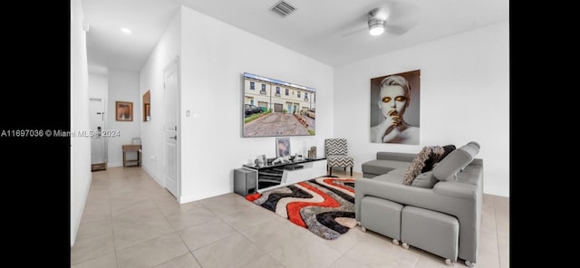 tiled living room with ceiling fan