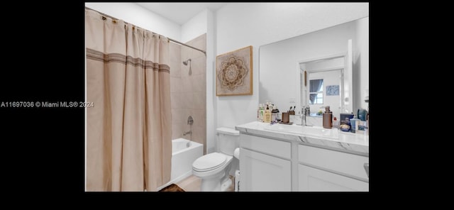 full bathroom with vanity, shower / bath combo, and toilet