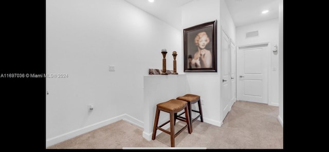 hall featuring light colored carpet