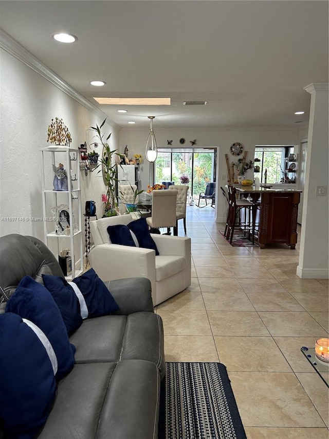 living room featuring light tile patterned floors and ornamental molding