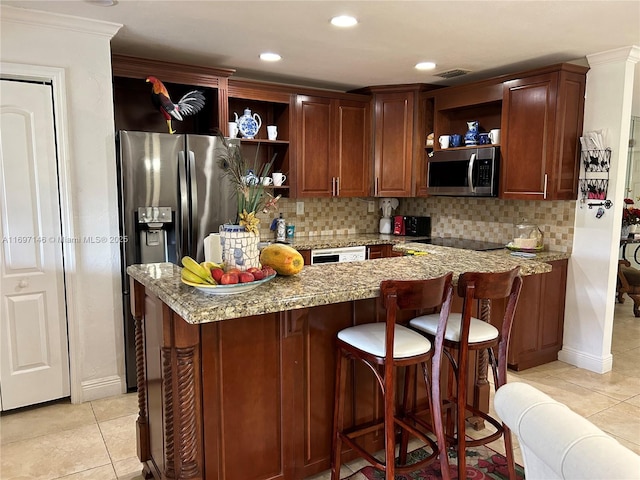 kitchen featuring light stone counters, appliances with stainless steel finishes, light tile patterned floors, and backsplash