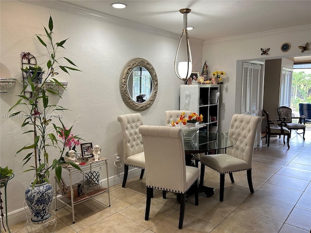 tiled dining space featuring ornamental molding