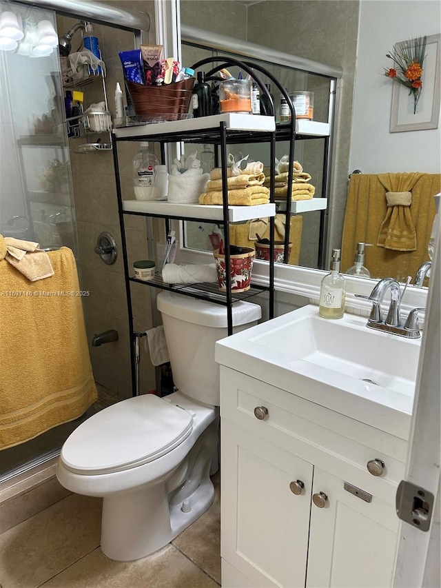 bathroom featuring vanity, toilet, and tile patterned flooring