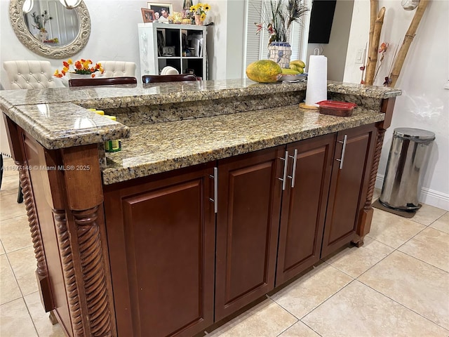 bar with light tile patterned floors and stone counters