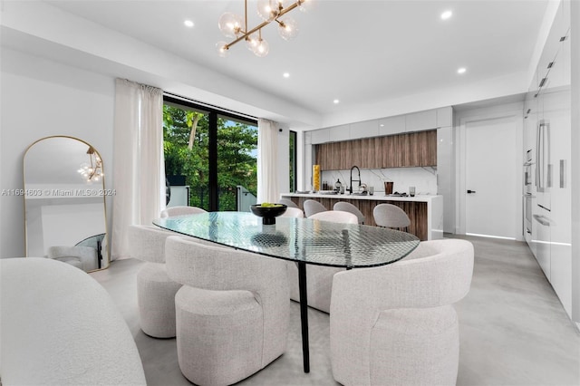 dining area with a notable chandelier and sink