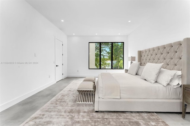 bedroom featuring concrete floors