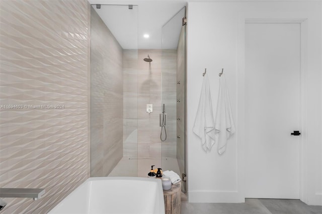 bathroom featuring shower with separate bathtub