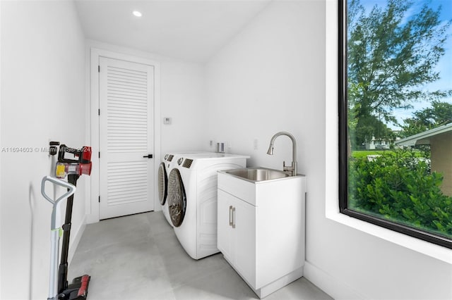 laundry area with plenty of natural light, independent washer and dryer, and sink