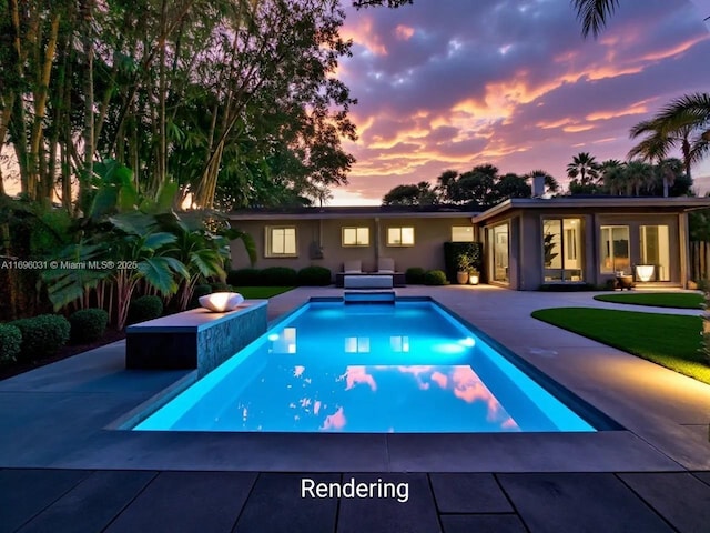 pool at dusk with a patio